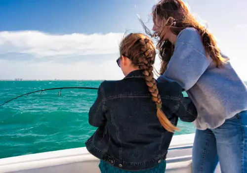 Two girls fish during a trip with one of the Best Fishing Captains in St. Petersburg FL: Captain Patrick from Tradewinds Fishing Charters