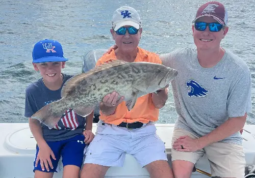 A family showing off their catch during Inshore Fishing near Anna Maria FL